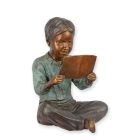 A BRONZE SCULPTURE OF A BOY READING