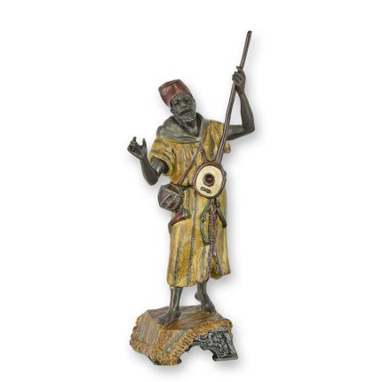 A BRONZE SCULPTURE OF AN ARAB BANJO PLAYER