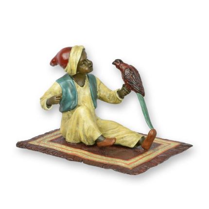 A BRONZE SCULPTURE OF A LITTLE BOY WITH PARROT