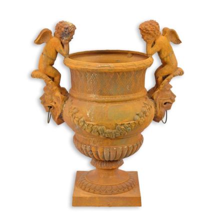A RUSTY CAST IRON GARDEN URN
